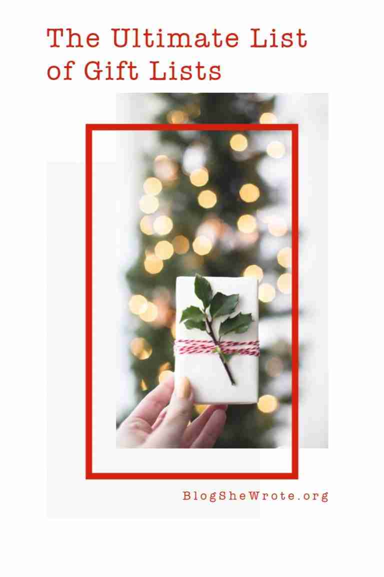 a woman's hand holding up a gift in front of a holiday tree