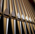 the pipes of a pipe organ pictured from the bottom up