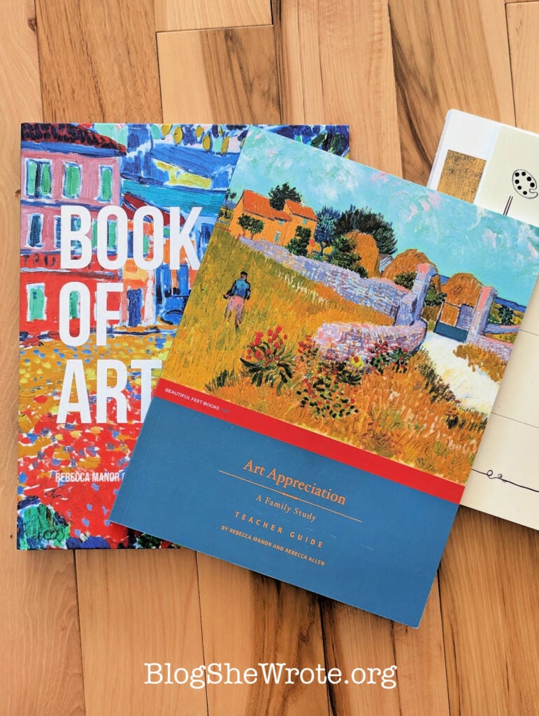 a stack of art appreciation books on a wood surface